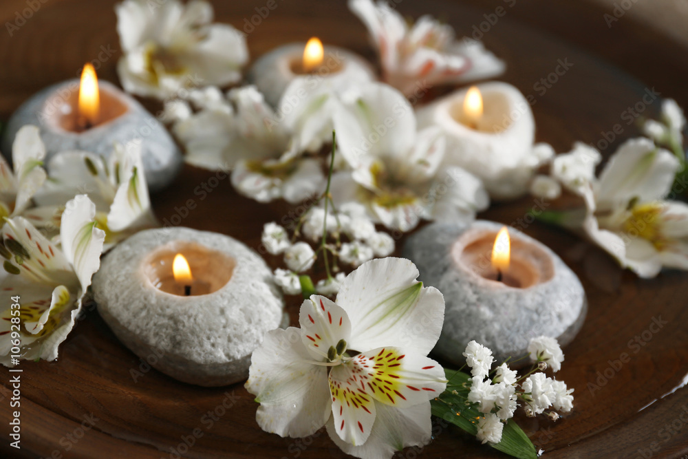 Beautiful exotic flowers and spa composition on the table, close up Beautiful exotic flowers and spa composition on the table, close up