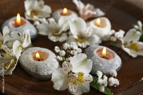 Beautiful exotic flowers and spa composition on the table  close up