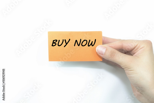 hand holding orange card written buy now over isolated