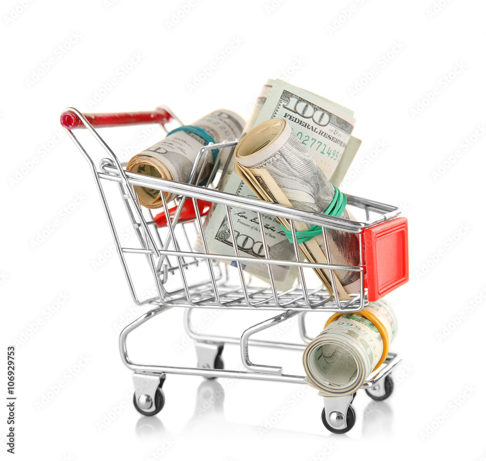 Small shopping trolley with dollars banknotes isolated on white