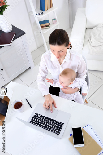Businesswoman with baby boy...