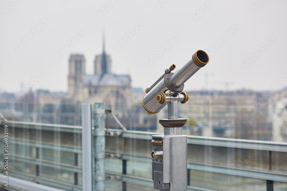 Touristic telescope with scenic view on the Notre Dame