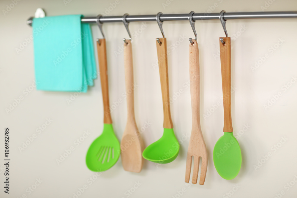 Set of wooden kitchen utensils and napkin hanging on the wall Set of wooden kitchen utensils and napkin hanging on the wall