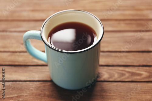 Mug of tea on wooden background