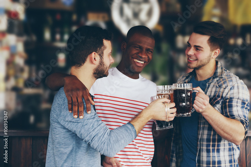 Group of happy friends drin...
