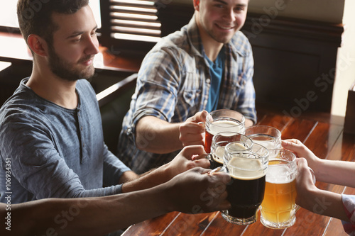 Group of happy friends drin...