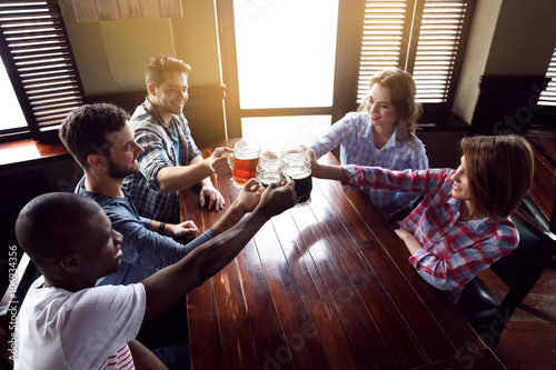 Group of happy friends drin...