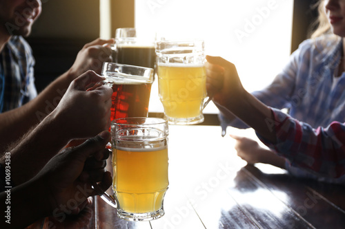 Friends drinking beer in pub