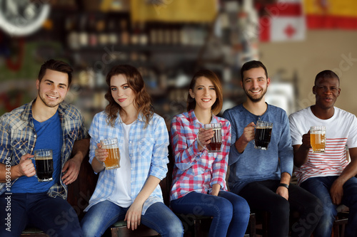 Group of happy friends drin...
