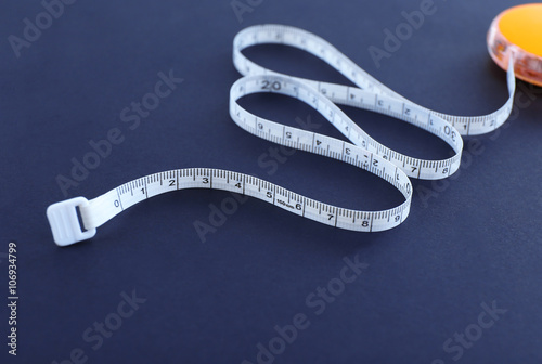 White measuring tape on a black background