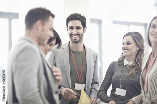 Businesswomen and businessmen in conference centre atrium