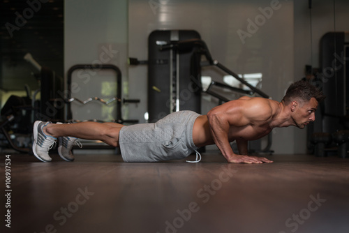 Young Man Doing Push Ups On Floor