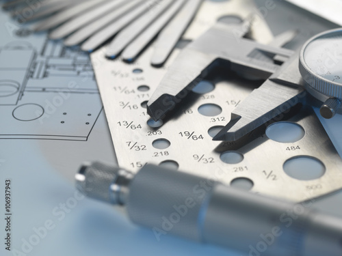 Engineering design -  screw gauge, feeler gauge and micrometer on blueprint