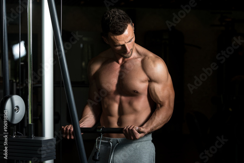 Bodybuilder Doing Heavy Weight Exercise For Biceps