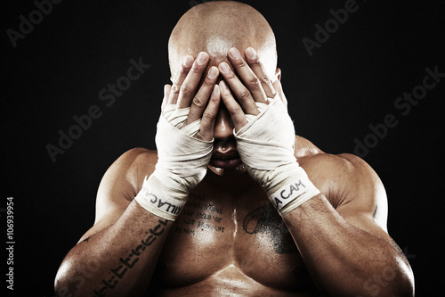 Mid adult boxer covering eyes photo