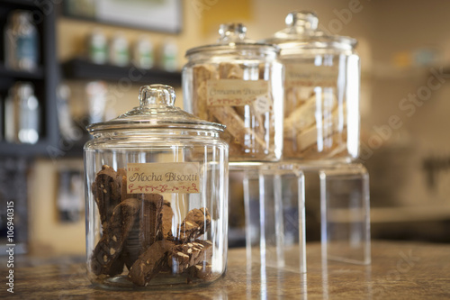 Close up of jars of biscotti on cafe counter photo