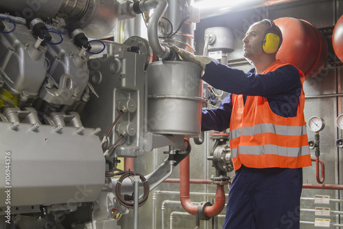 Technician making a check in power station