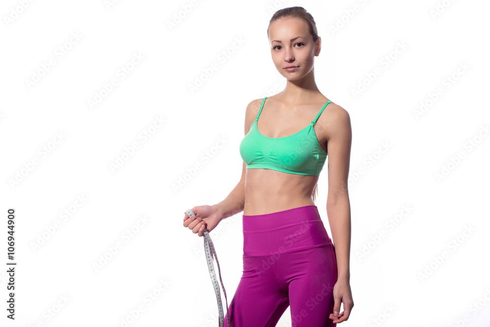 attractive fitness model with measuring tape on a white background attractive fitness model with measuring tape on a white background