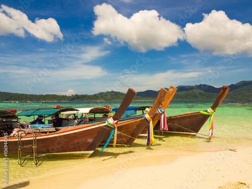 Long tail wooden boat and tropical beach