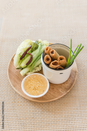 plate of spring rolls with sweet chili dip sauce