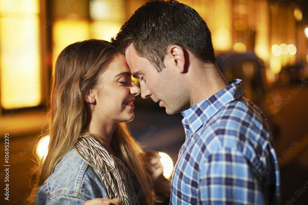 Romantic couple face to face city street at night Romantic couple face to face city street at night