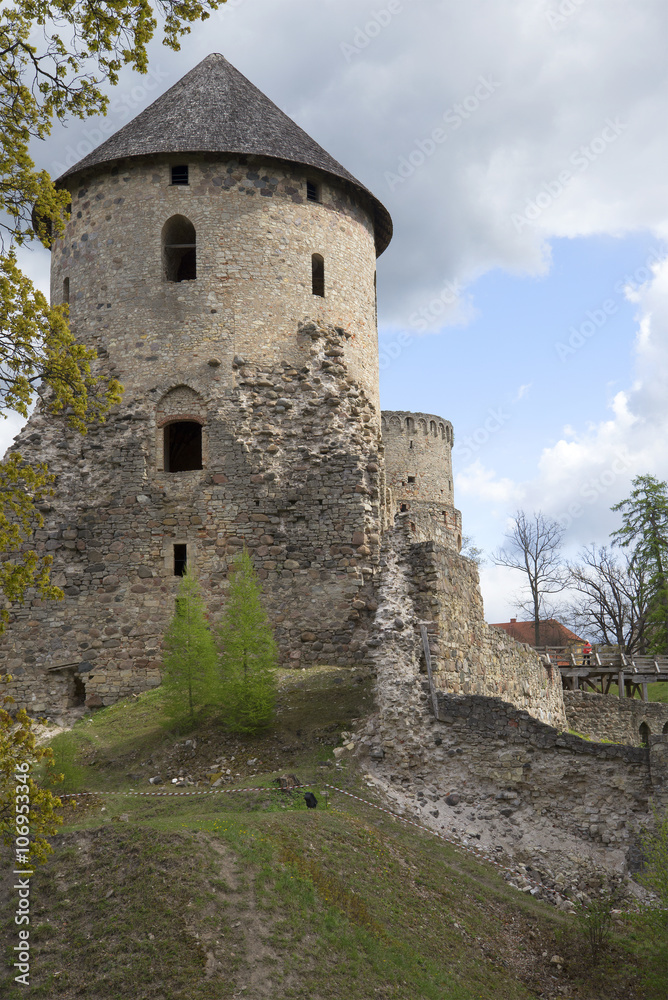 The tower of a medieval castle cloudy may afternoon. Cesis, Latvia