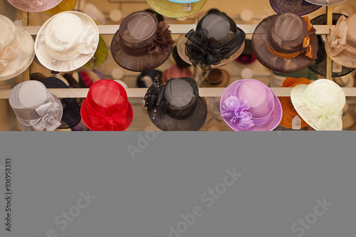 Rows of colorful hats in traditional milliners shop photo