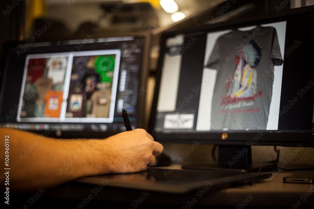 Man using graphic tablet and pen to design t-shirt Man using graphic tablet and pen to design t-shirt