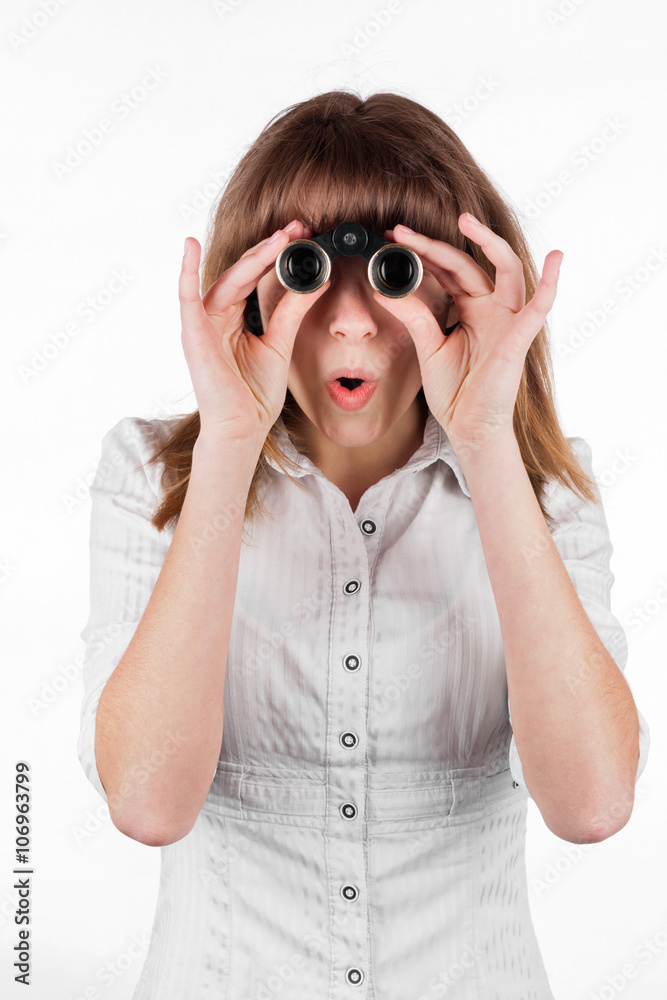 Beautiful girl searching with binoculars and looking surprised Beautiful girl searching with binoculars and looking surprised
