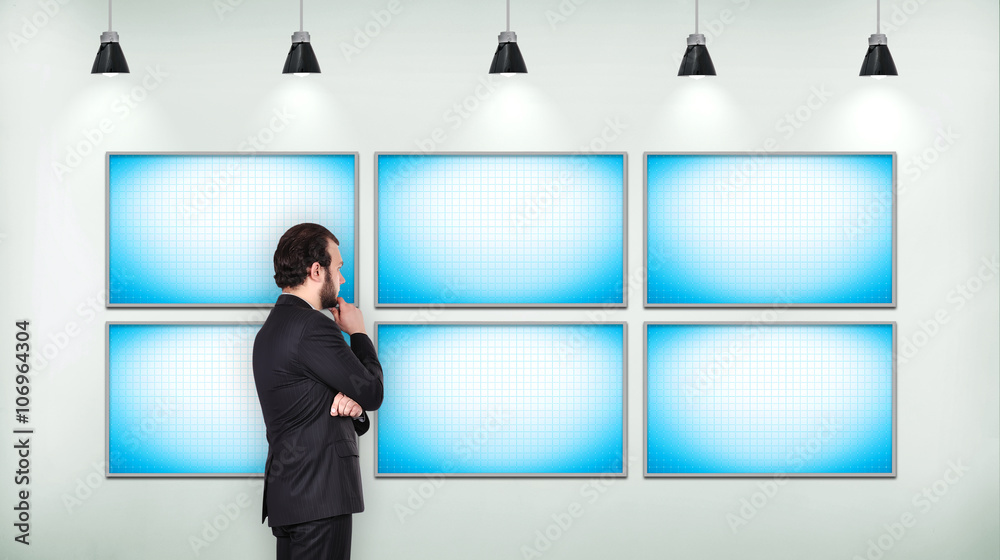 Businessman looking on blank six tv screen Businessman looking on blank six tv screen