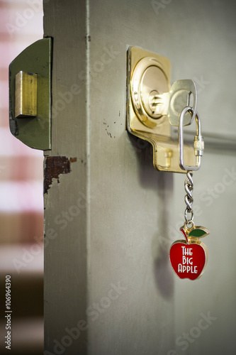 Open front door with key and souvenir keyring