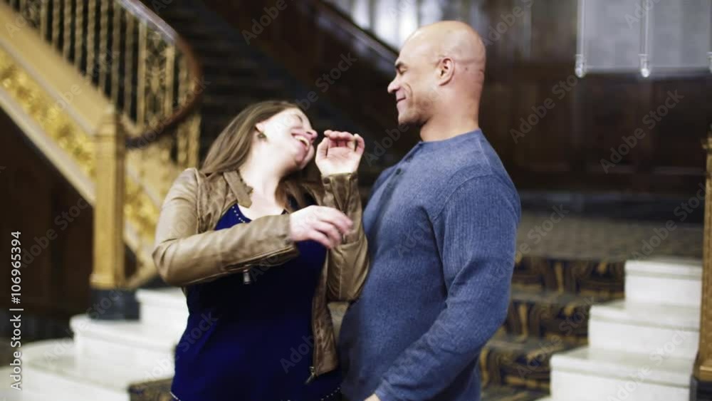 Dating couple embraces and kisses in a historic theater setting. Medium shot, recorded in slow motion 135fps. Dating couple embraces and kisses in a historic theater setting. Medium shot, recorded in slow motion 135fps.
