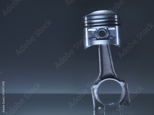 Car engine piston on grey background