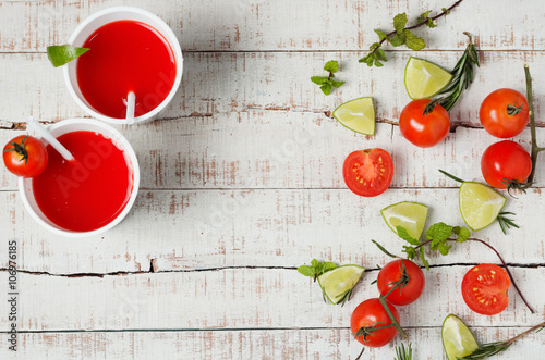 two red drinks with fresh tomato and lime