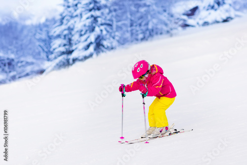 Little girl skiing in the mountains