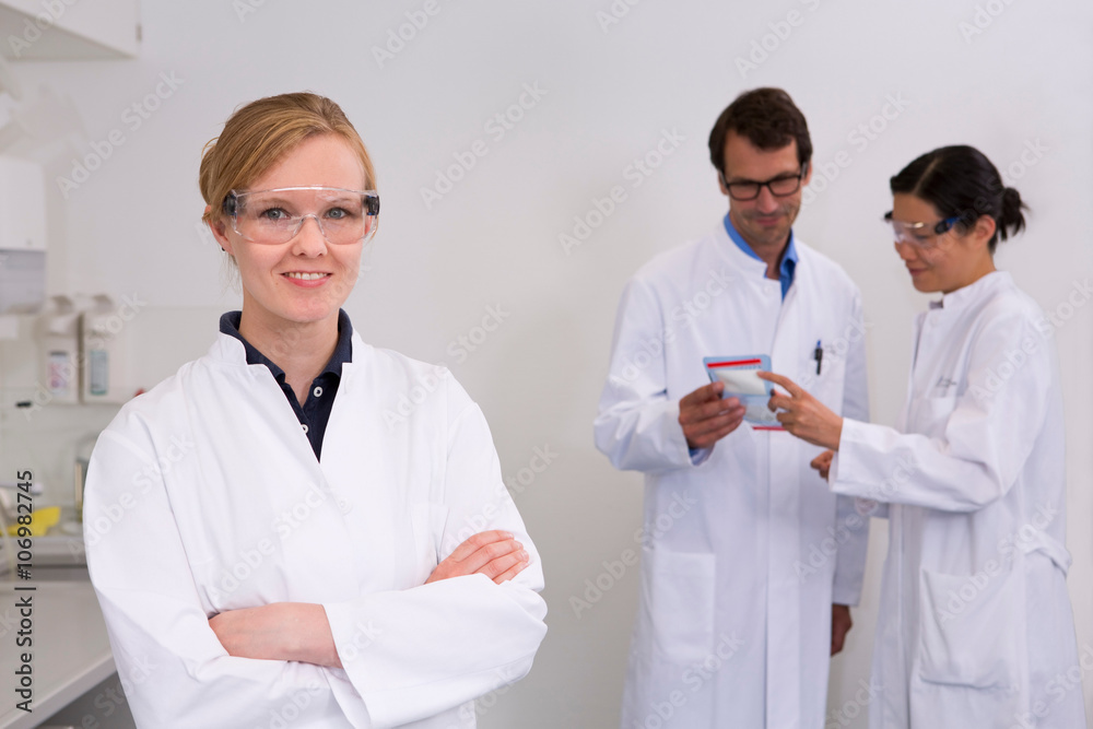 Group of scientists working in laboratory Group of scientists working in laboratory