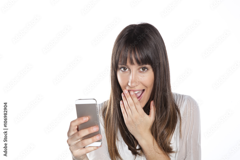 Portrait of an amazed woman reading a text message against a white background Portrait of an amazed woman reading a text message against a white background