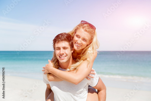 Portrait of man carrying girlfriend on his back