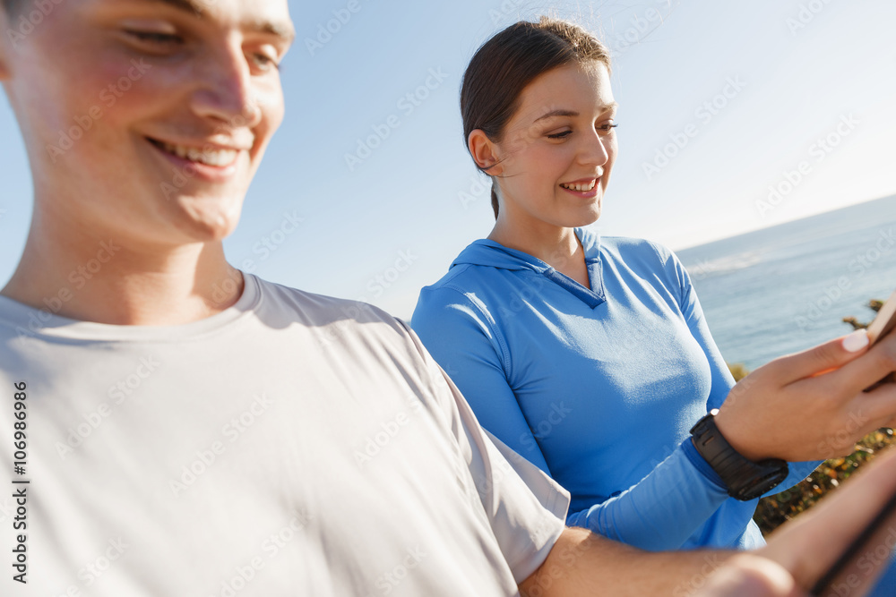 Young couple with smartphones outdoors Young couple with smartphones outdoors