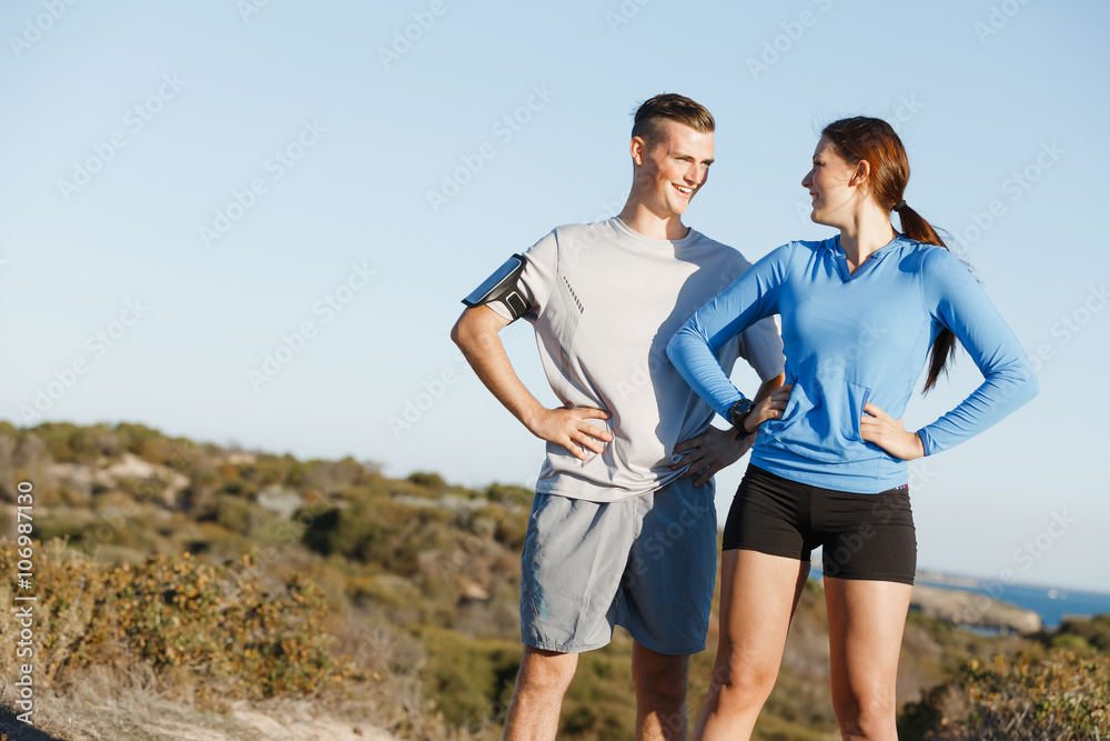 Young couple on beach training together Young couple on beach training together