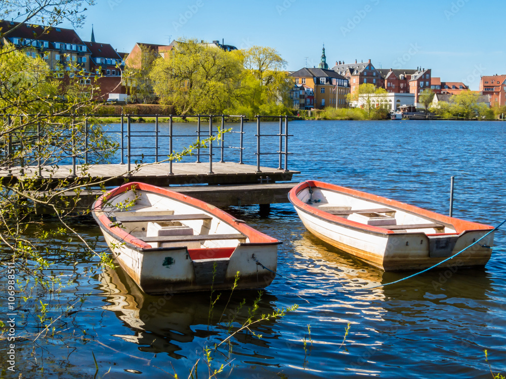 Two old row boats moored on the lake