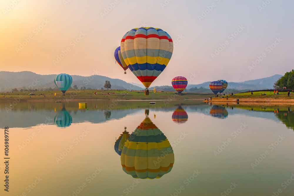 Fototapeta premium Hot air color balloon over lake with sunset time, Chiang Rai Province, Thailand