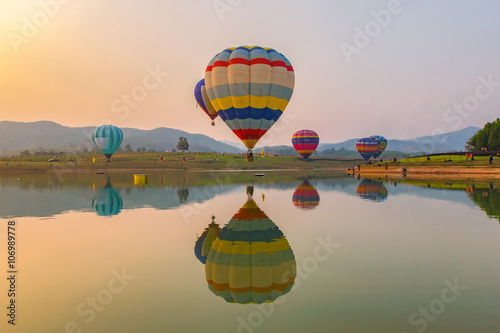 Hot air color balloon over lake with sunset time, Chiang Rai Province, Thailand