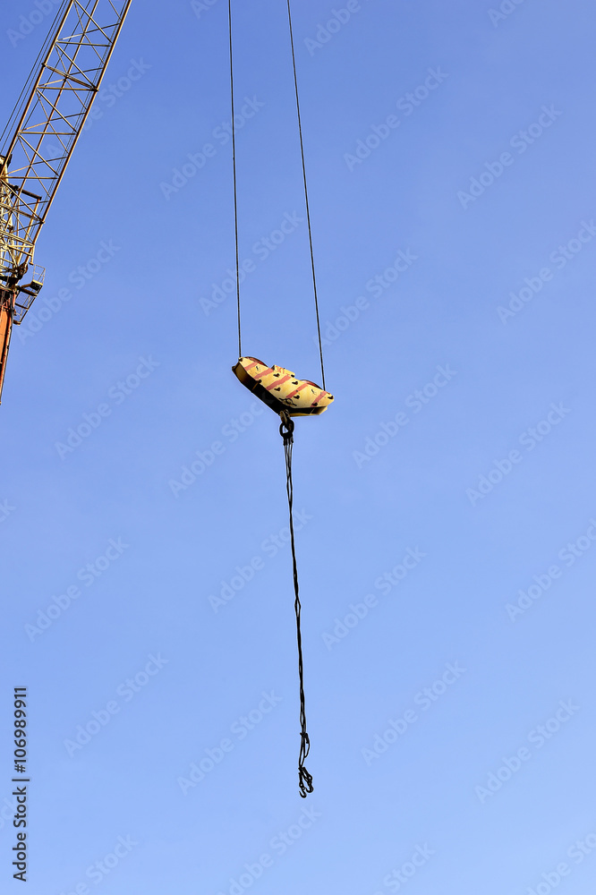 Crane and building construction site against blue sky Crane and building construction site against blue sky