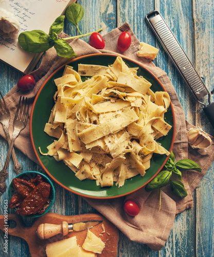 Papardelle italian pasta with fresh cherry tomatoes and basil photo