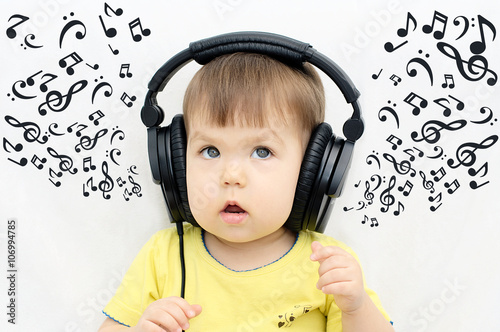 Music sheets from the headphones of little girl