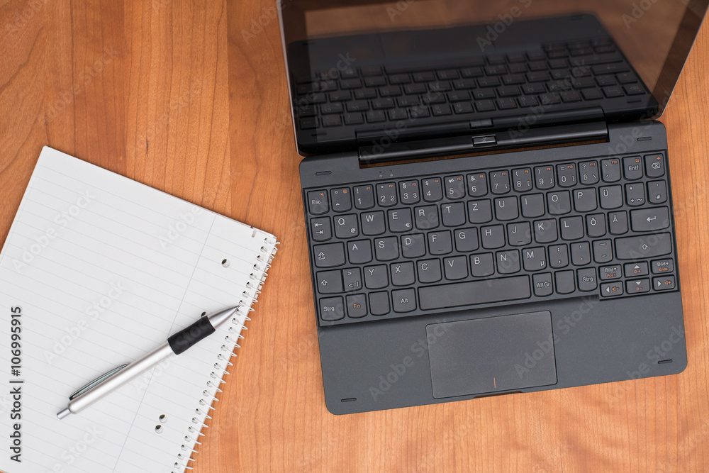 notebook and notepad on wooden table from above notebook and notepad on wooden table from above
