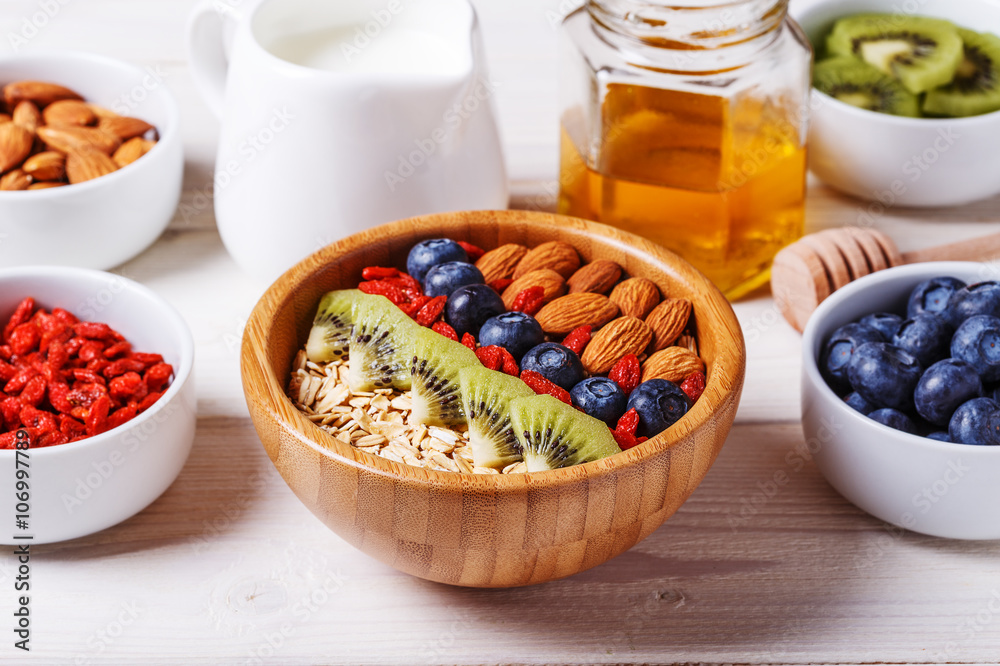 Healthy breakfast - bowl of oat flakes with fresh fruit, almond. Healthy breakfast - bowl of oat flakes with fresh fruit, almond.