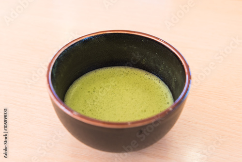 fresh green tea in traditional cup