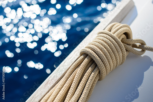 Yachting background - rope on board of small yacht - sail boat with sea in background © dell